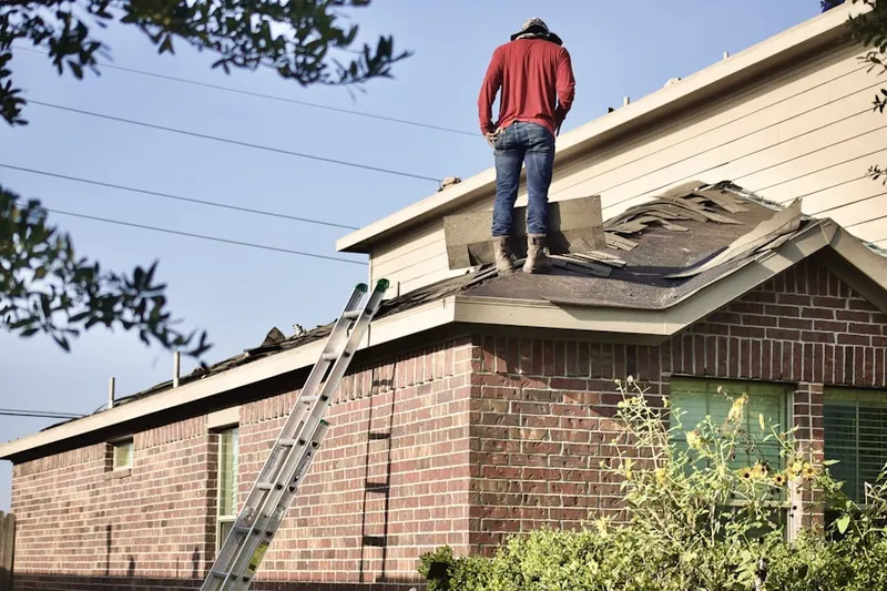 Professional roofer working on a residential roof in Westwood Lakes